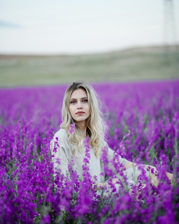 Person stretching gently, looking calm and focused in a tranquil environment.