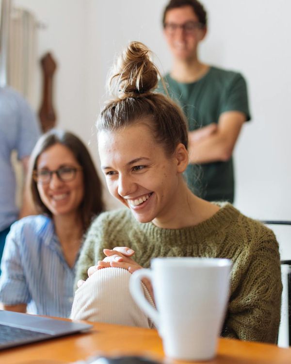 Woman feeling energized and happy in a bright room.